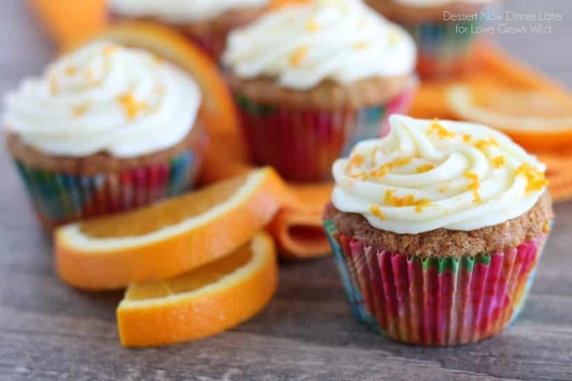 Moist, fluffy Carrot Cake Cupcakes combined with the tropical flavor of coconut, and topped with an Orange Cream Cheese Frosting! You have to try this delicious dessert! | LoveGrowsWild.com
