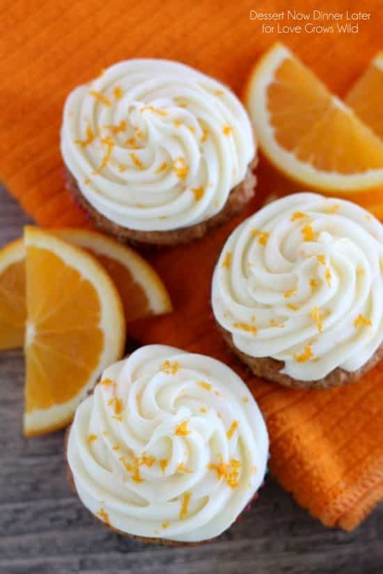 Moist, fluffy Carrot Cake Cupcakes combined with the tropical flavor of coconut, and topped with an Orange Cream Cheese Frosting! You have to try this delicious dessert! | LoveGrowsWild.com
