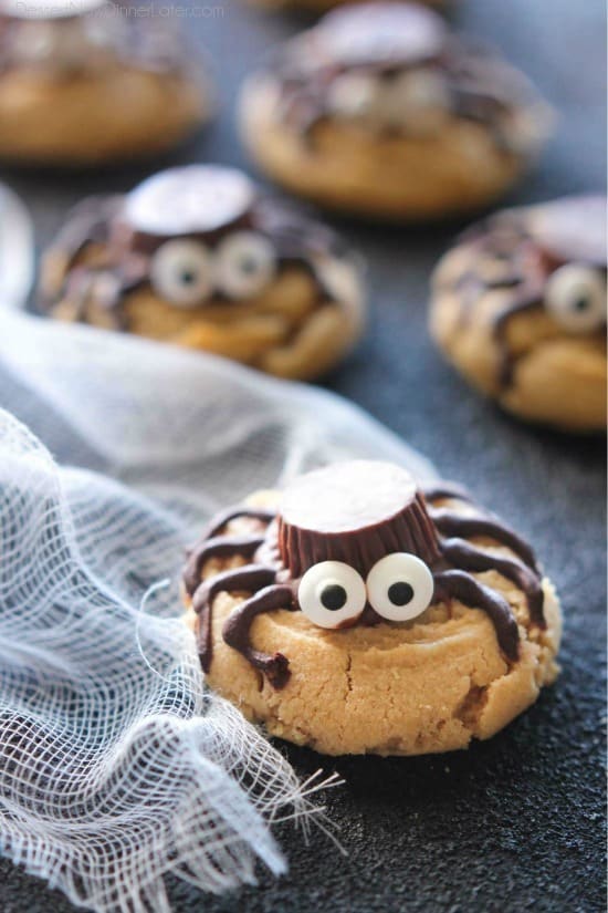Not all Halloween food has to be gross and gory! These super cute spider cookies are made with peanut butter cups, chocolate, candy eyes, and the BEST peanut butter cookie recipe you'll ever try!