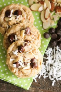 Almond Coconut Chocolate Chip Cookies are loaded with sliced almonds, shredded coconut, chocolate chips and flavored extracts for an Almond Joy inspired twist on the traditional chocolate chip cookie.