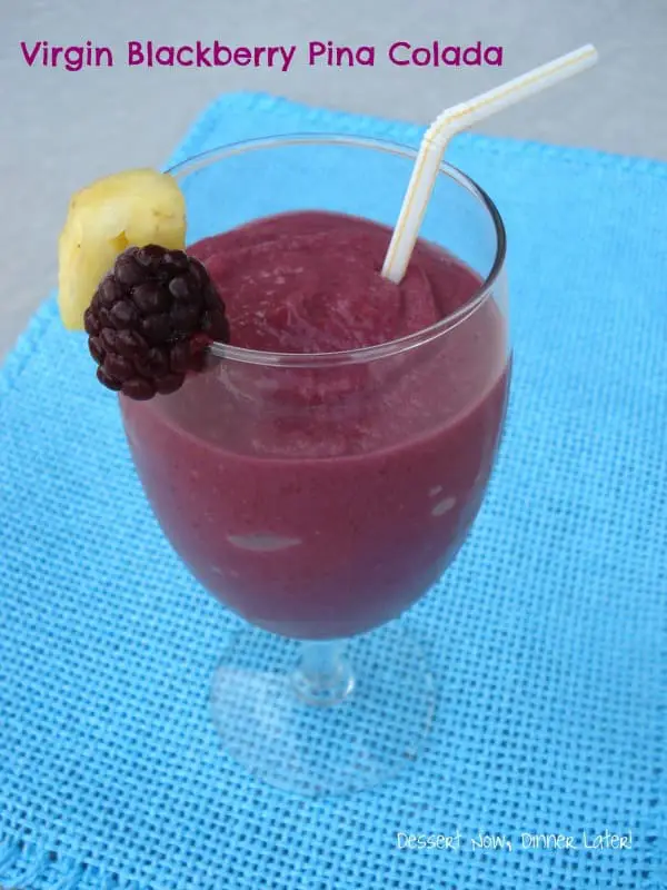 Virgin Blackberry Pina Colada in a glass garnished with a fresh pineapple chunk and blackberry.