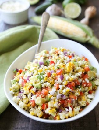 Corn Salad with Queso Fresco is loaded with grilled corn, crisp onions and peppers, and creamy avocado, all topped with a homemade cilantro lime vinaigrette and generous helping of delicious queso fresco. A great side dish for your summer barbecue.