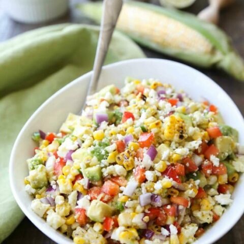 Corn Salad with Queso Fresco is loaded with grilled corn, crisp onions and peppers, and creamy avocado, all topped with a homemade cilantro lime vinaigrette and generous helping of delicious queso fresco. A great side dish for your summer barbecue.