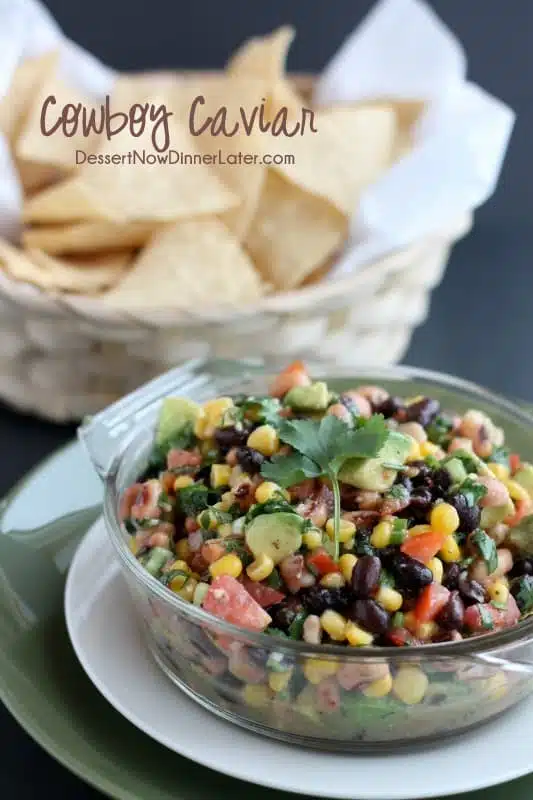 Cowboy Caviar is a chunky salsa-type dip with beans, avocado, tomatoes, corn and a zesty dressing. Great for picnics, potlucks, parties, or a game day snack!