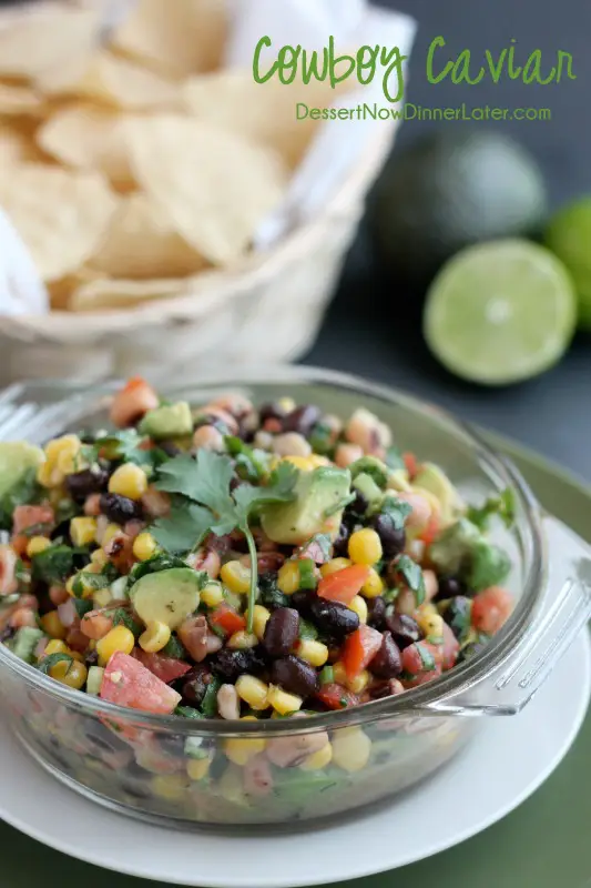 Cowboy Caviar is a chunky salsa-type dip with beans, avocado, tomatoes, corn and a zesty dressing. Great for picnics, potlucks, parties, or a game day snack!