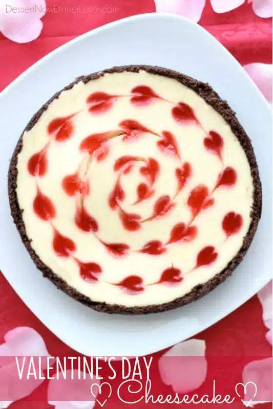 Cheesecake with strawberry heart shaped swirl on top.