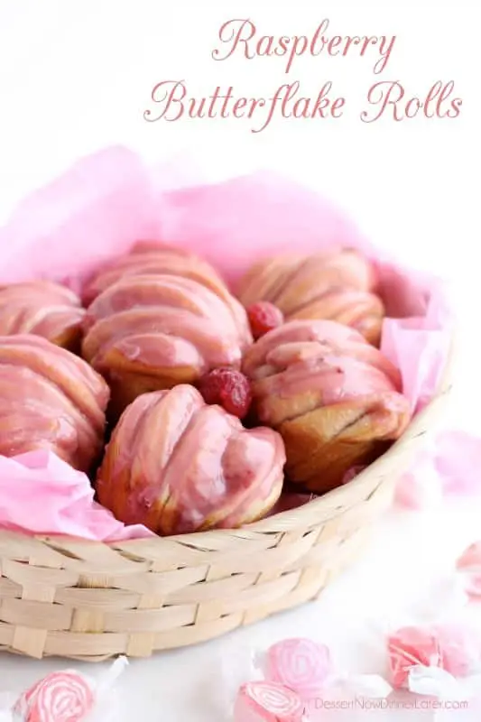 Raspberry Butterflake Rolls in a basket with raspberry glaze on top.