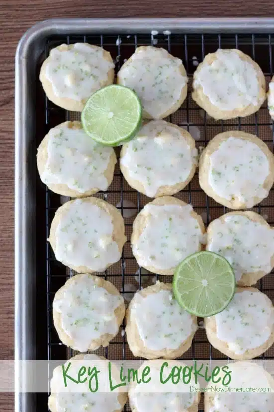 Key lime cookies on a wire rack with a pan underneath to catch the dripping glaze on top.