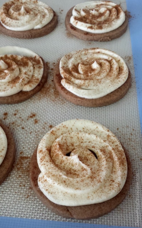 Cinnamon Roll Sugar Cookies - a basic sugar cookie dough with the addition of cinnamon, topped with the best cream cheese frosting and extra cinnamon for fun!