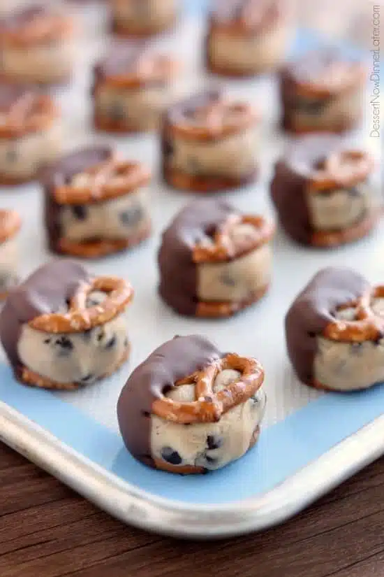 Cookie Dough Pretzel Bites - eggless chocolate chip cookie dough sandwiched between two pretzels and dipped in milk chocolate! From DessertNowDinnerLater.com