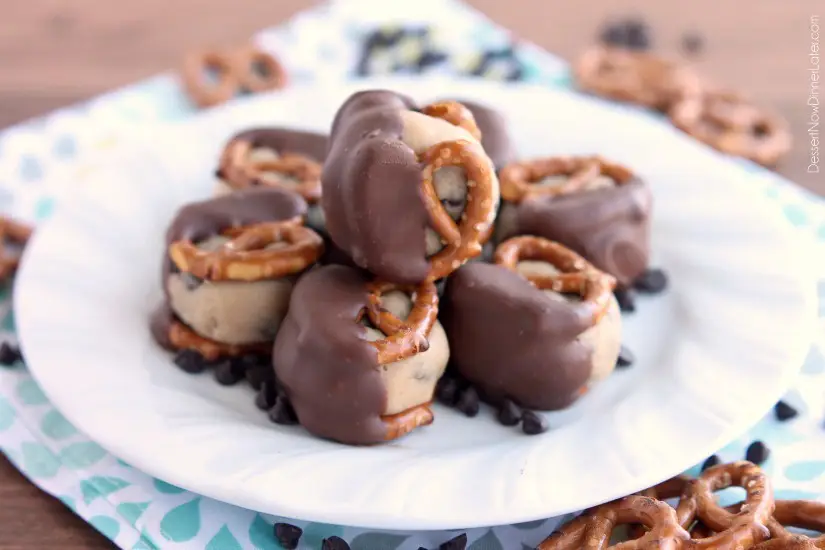 Cookie Dough Pretzel Bites - eggless chocolate chip cookie dough sandwiched between two pretzels and dipped in milk chocolate! From DessertNowDinnerLater.com