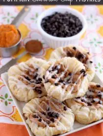 Pumpkin Chocolate Chip Pastries are made with frozen puff pastry dough, a spiced pumpkin cream cheese, and mini chocolate chips! They are especially delicious warm from the oven with a powdered sugar glaze! From DessertNowDinnerLater.com