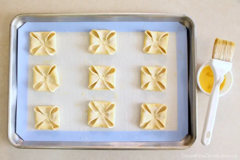 Pumpkin Chocolate Chip Pastries - step 2 - fold corners in and egg wash edges (DessertNowDinnerLater.com)