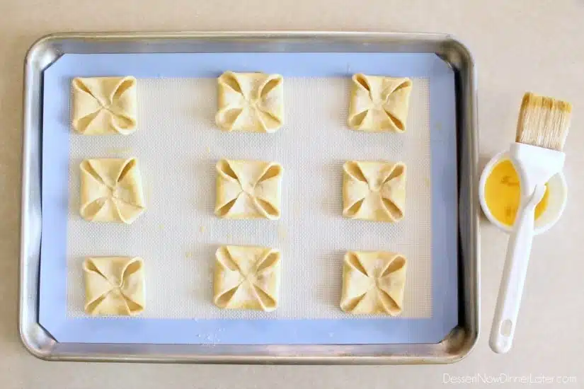 Pumpkin Chocolate Chip Pastries - step 2 - fold corners in and egg wash edges (DessertNowDinnerLater.com)