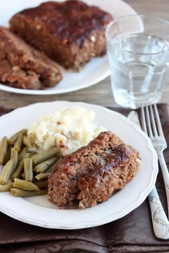 Steak Lovers' Meatloaf - A1 steak sauce, garlic, and onions on the inside, with more steak sauce slathered on the outside, makes this meatloaf both moist and delicious! From DessertNowDinnerLater.com