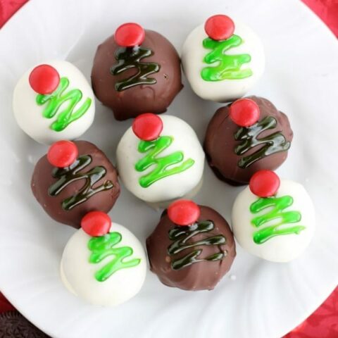 These traditionally made OREO Cookie Balls are decorated with green gel and a red candy coated chocolate piece for a festive Christmas Tree treat! From DessertNowDinnerLater.com