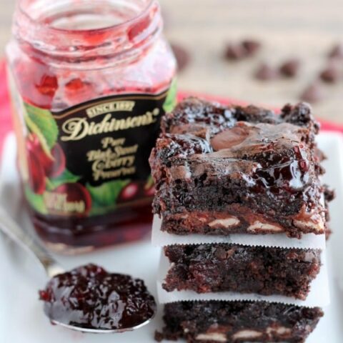 Dark Chocolate Cherry Brownies are made from a doctored box mix that has cherry filled morsels and cherry preserves swirled throughout. From DessertNowDinnerLater.com