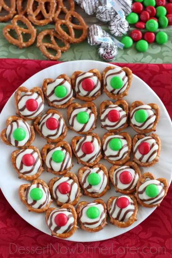 These festive Christmas Pretzel Hugs are melted just enough to press an M&M on the top.  Let the chocolate set back up and then package them for neighbor gifts, or place them on a plate for the perfect salty-sweet treat! From DessertNowDinnerLater.com
