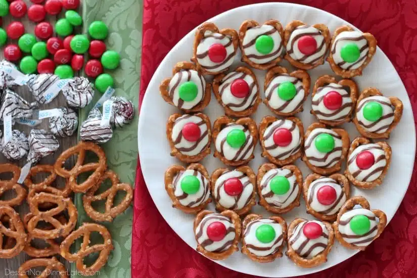 These festive Christmas Pretzel Hugs are melted just enough to press an M&M on the top.  Let the chocolate set back up and then package them for neighbor gifts, or place them on a plate for the perfect salty-sweet treat! From DessertNowDinnerLater.com