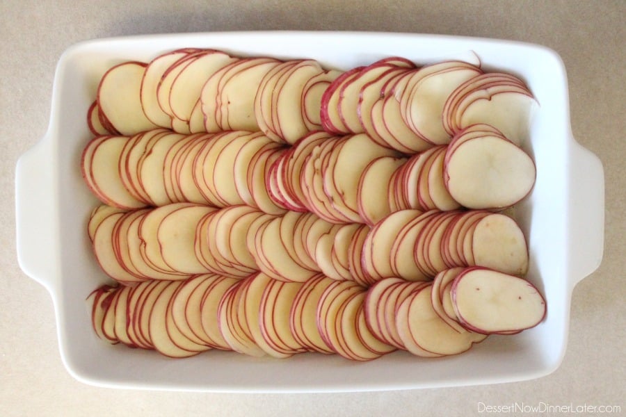 Tuscan Scalloped Potatoes - layer thinly sliced potatoes in a greased dish.