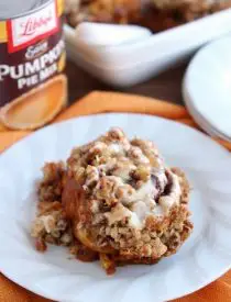 Cinnamon Pumpkin Crumble - frozen cinnamon rolls smothered in pumpkin pie mix, spices, and a crispy-crunchy streusel, then baked to perfection and served with a drizzle of cream cheese frosting and caramel!