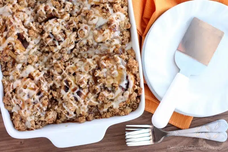 Cinnamon Pumpkin Crumble - frozen cinnamon rolls smothered in pumpkin pie mix, spices, and a crispy-crunchy streusel, then baked to perfection and served with a drizzle of cream cheese frosting and caramel!