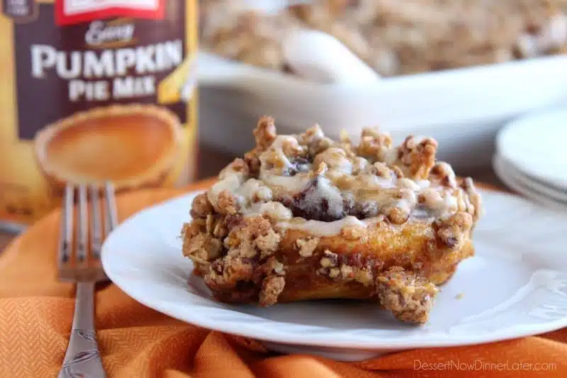 Cinnamon Pumpkin Crumble - frozen cinnamon rolls smothered in pumpkin pie mix, spices, and a crispy-crunchy streusel, then baked to perfection and served with a drizzle of cream cheese frosting and caramel!