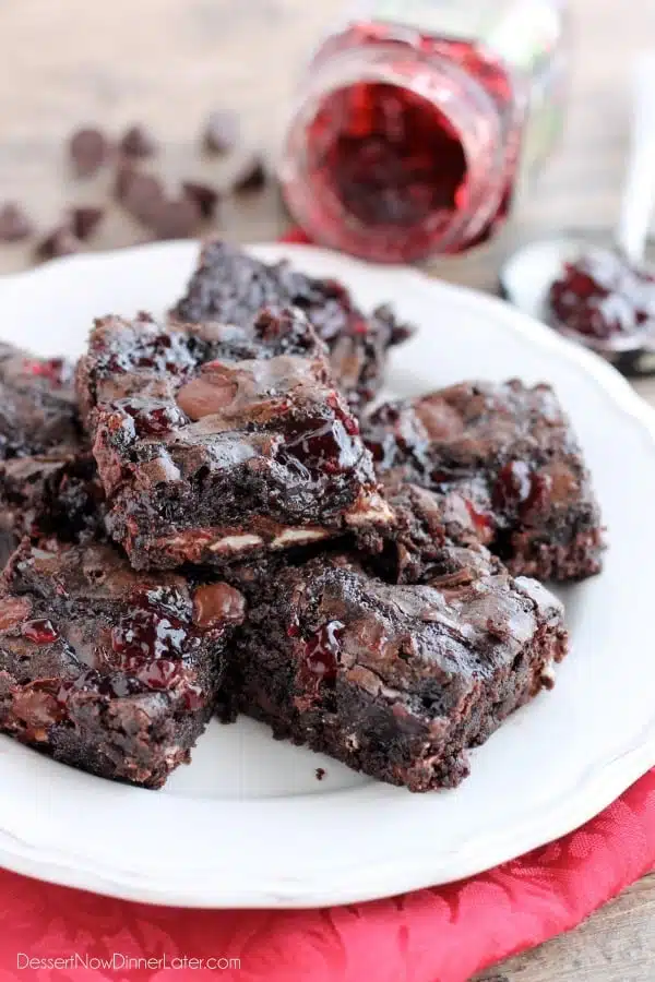 Dark Chocolate Cherry Brownies are made from a doctored box mix that has cherry filled morsels and cherry preserves swirled throughout. From DessertNowDinnerLater.com