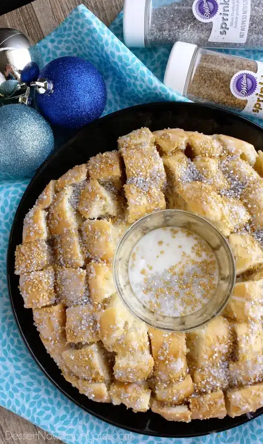 This New Year’s Party Loaf is filled with honey butter, topped with a powdered sugar glaze, and made to sparkle with edible silver and gold pearlized sugar sprinkles.