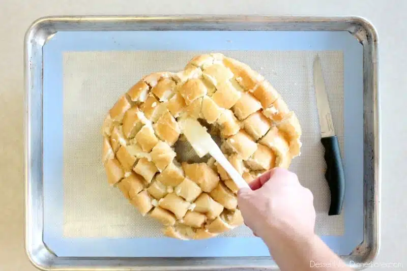 This New Year’s Party Loaf is filled with honey butter, topped with a powdered sugar glaze, and made to sparkle with edible silver and gold pearlized sugar sprinkles.