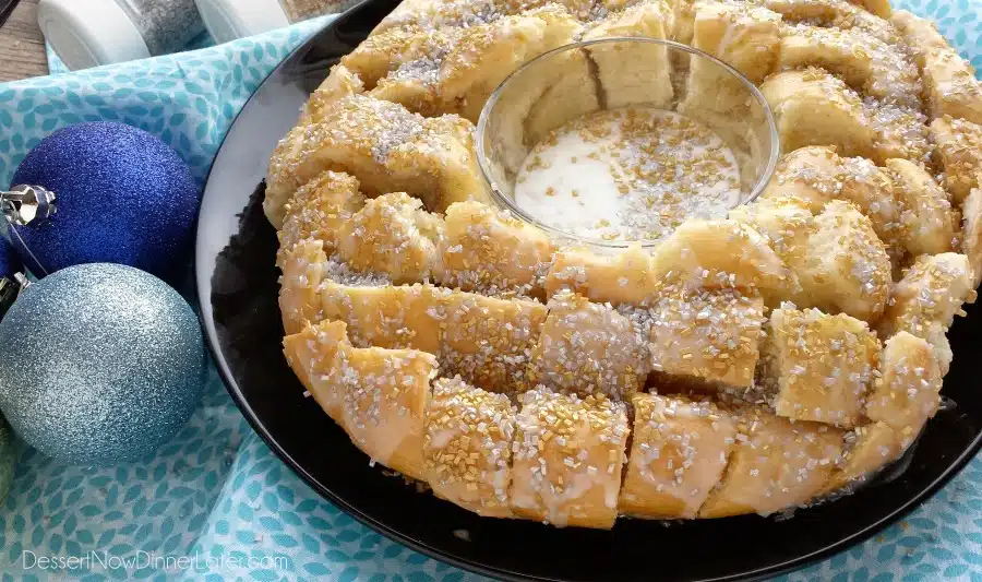 This New Year’s Party Loaf is filled with honey butter, topped with a powdered sugar glaze, and made to sparkle with edible silver and gold pearlized sugar sprinkles.