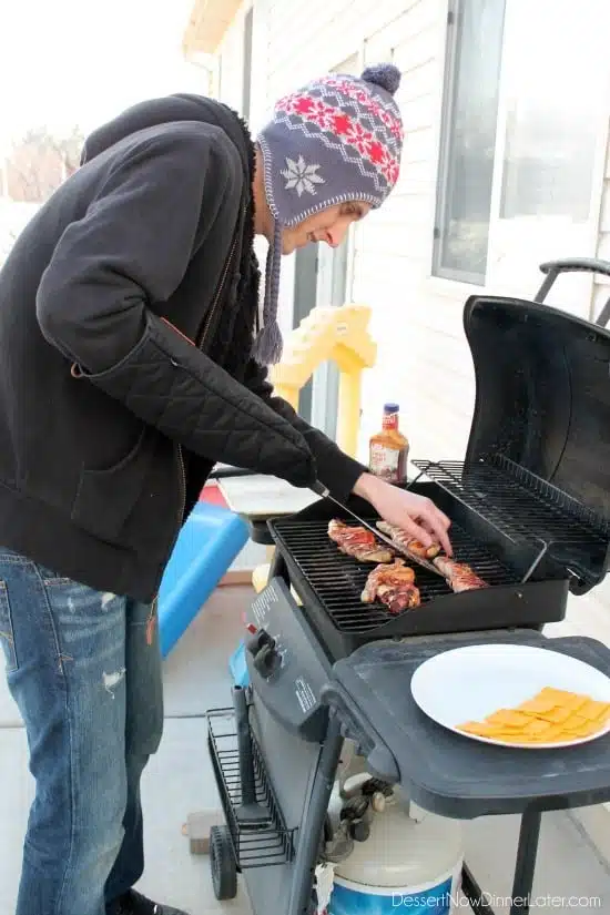 Using the Evergriller Grill 'N' Flip Mitt to keep warm while grilling outside in the cold!