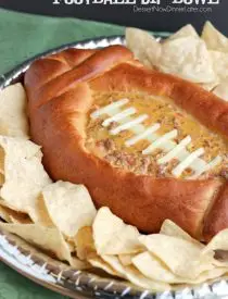 This Football Dip Bowl is made with a frozen whole wheat dough that is shaped into a football with a place to hold your favorite queso dip! Make laces with cut up string cheese and you have a football themed party food! (Step-by-step photos included.)