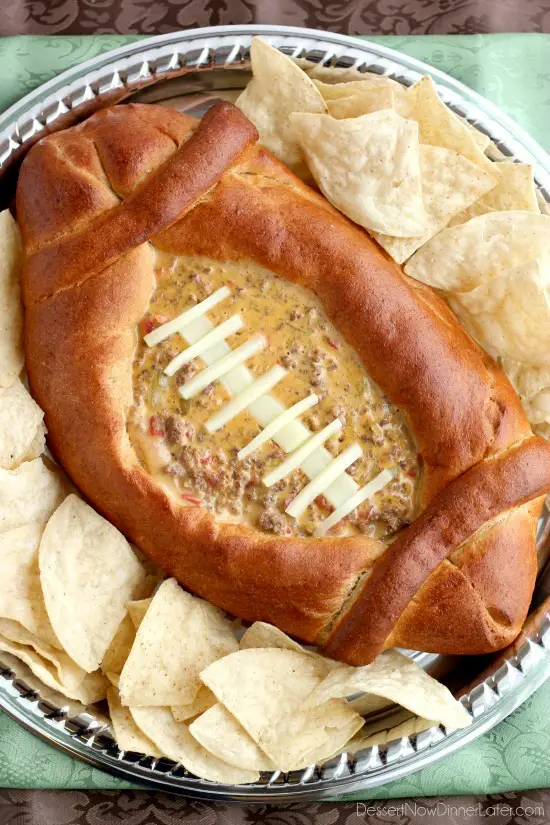 This Football Dip Bowl is made with a frozen whole wheat dough that is shaped into a football with a place to hold your favorite queso dip! Make laces with cut up string cheese and you have a football themed party food! (Step-by-step photos included.)