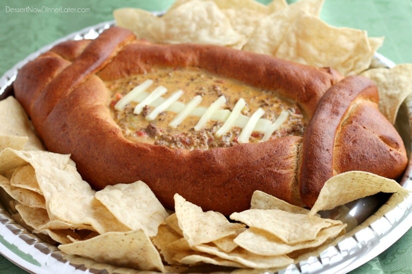 This Football Dip Bowl is made with a frozen whole wheat dough that is shaped into a football with a place to hold your favorite queso dip! Make laces with cut up string cheese and you have a football themed party food! (Step-by-step photos included.)