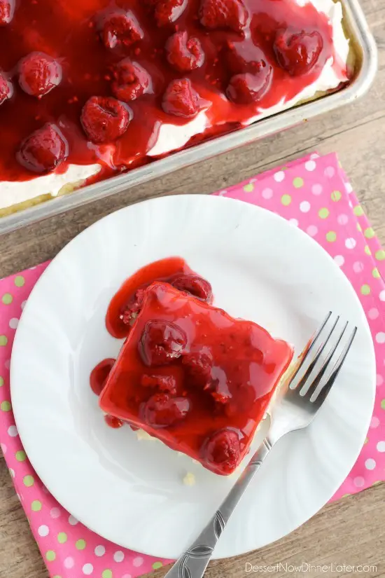 This EASY and delicious Raspberry Shortcake Sheet Cake is layered with light, fluffy white cake, topped with whipped cream cheese frosting and a fresh raspberry glaze! Perfect for parties, potlucks, or a Valentine's Day dessert!