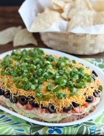 Seven Layer Dip is a classic party snack or football food. This version has a secret ingredient to make it a dip that is sure to get gobbled up by your guests!