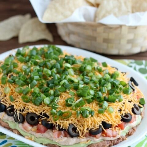 Seven Layer Dip is a classic party snack or football food. This version has a secret ingredient to make it a dip that is sure to get gobbled up by your guests!