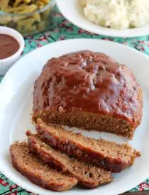 This Slow Cooker Meatloaf has a delicious savory-sweet brown sugar and balsamic glaze on top, and is cooked on a sheet of parchment paper that easily lifts the meatloaf out of the slow cooker when it's done cooking.