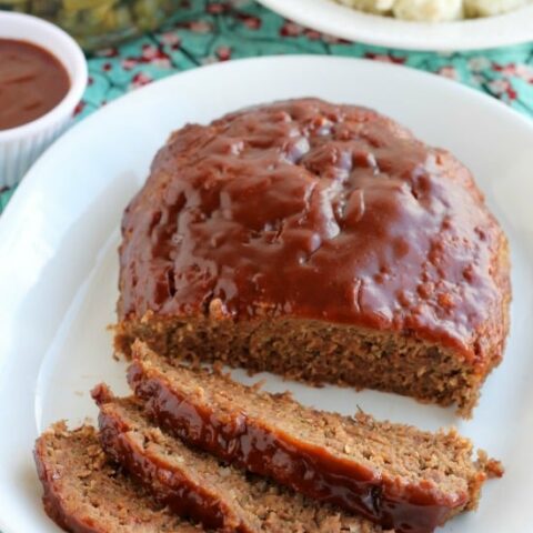 This Slow Cooker Meatloaf has a delicious savory-sweet brown sugar and balsamic glaze on top, and is cooked on a sheet of parchment paper that easily lifts the meatloaf out of the slow cooker when it's done cooking.