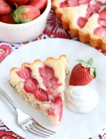 This Strawberry Cake is lightly sweet, layered with fresh sliced strawberries, and is served with a side of coconut whipped cream. A stunning and delicious dessert for any occasion or Valentine's Day.