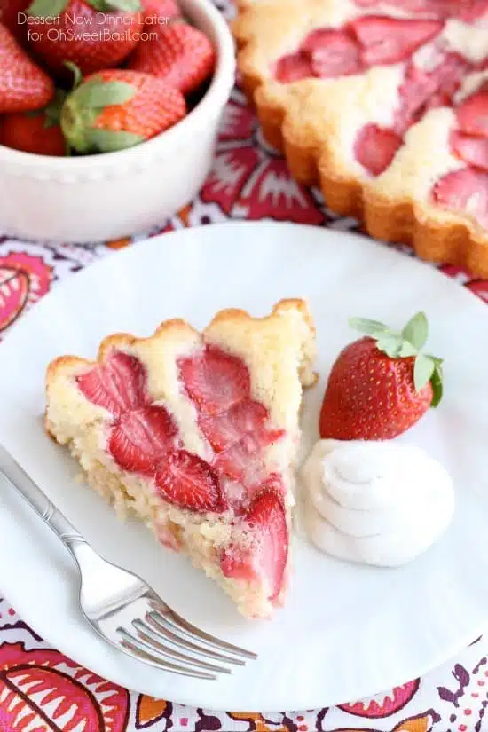 This Strawberry Cake is lightly sweet, layered with fresh sliced strawberries, and is served with a side of coconut whipped cream. A stunning and delicious dessert for any occasion or Valentine's Day.