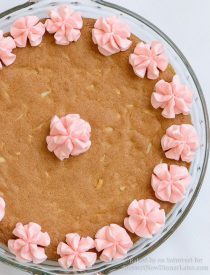 Almond Cherry Cookie Cake -Almond flavored sugar cookie cake with slivered almonds throughout and topped with cherry frosting. The best sugar cookie you will ever have!