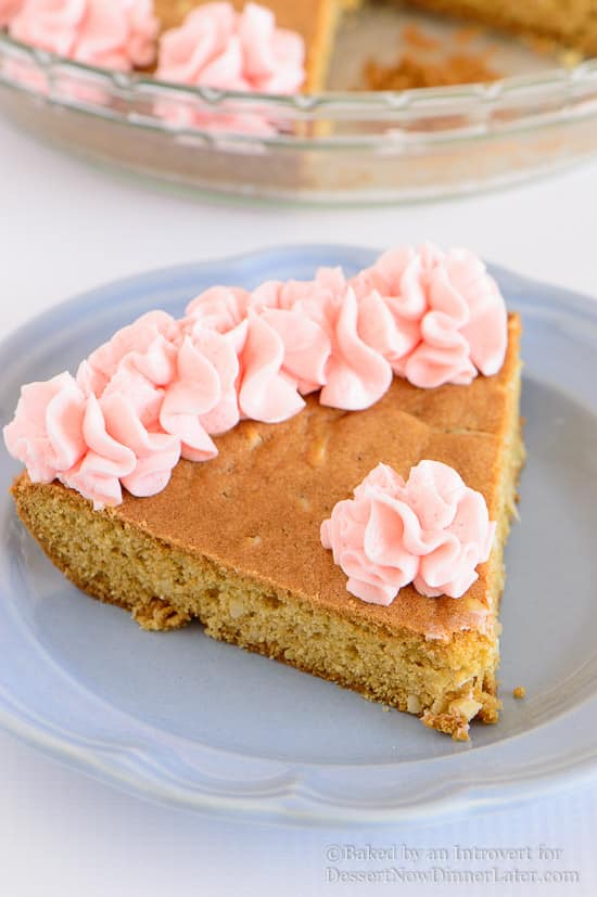 Almond Cherry Cookie Cake - Almond flavored sugar cookie cake with slivered almonds throughout and topped with cherry frosting. The best sugar cookie you will ever have!