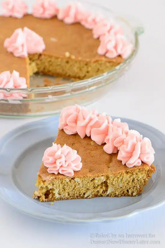 Almond Cherry Cookie Cake - Almond flavored sugar cookie cake with slivered almonds throughout and topped with cherry frosting. The best sugar cookie you will ever have!