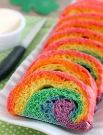 Rainbow Bread - Rhodes frozen dough is kneaded into 6 bright colors and rolled into a fun rainbow loaf (step-by-step photo instructions included). The perfect bread to eat with butter for dinner or use for breakfast french toast on St. Patrick's Day!