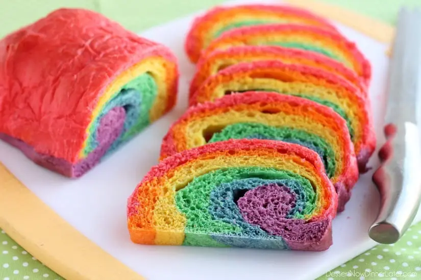 Rainbow Bread - Rhodes frozen dough is kneaded into 6 bright colors and rolled into a fun rainbow loaf (step-by-step photo instructions included). The perfect bread to eat with butter for dinner or use for breakfast french toast on St. Patrick's Day!