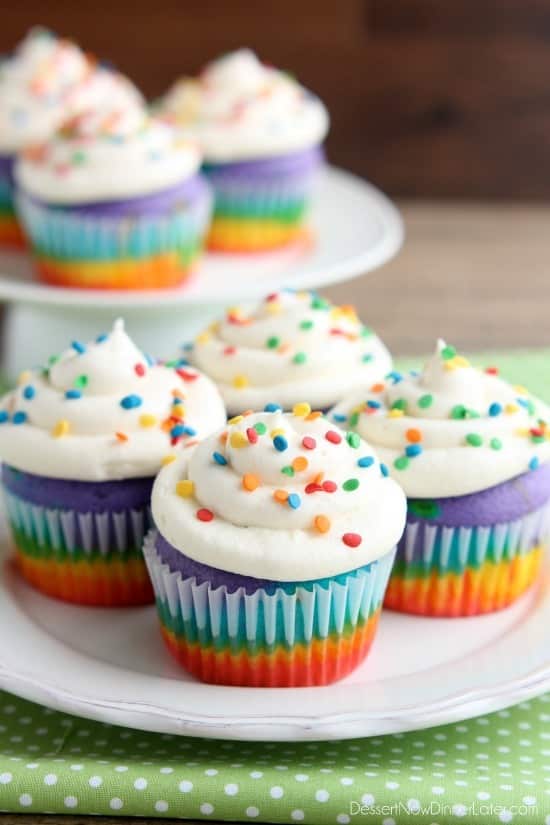 These Rainbow Cupcakes are made with a simple boxed white cake mix, colored, and layered to make a rainbow, with whipped cream cheese frosting on top! (Photo tutorial, plus tips on baking cupcakes to perfection!)