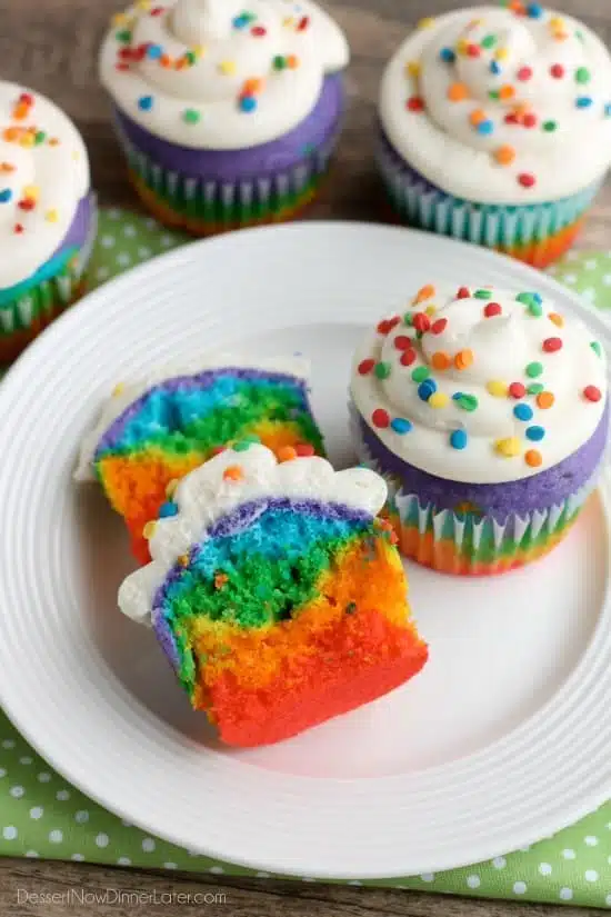 These Rainbow Cupcakes are made with a simple boxed white cake mix, colored, and layered to make a rainbow, with whipped cream cheese frosting on top! (Includes photo tutorial, and tips on baking cupcakes to perfection!)