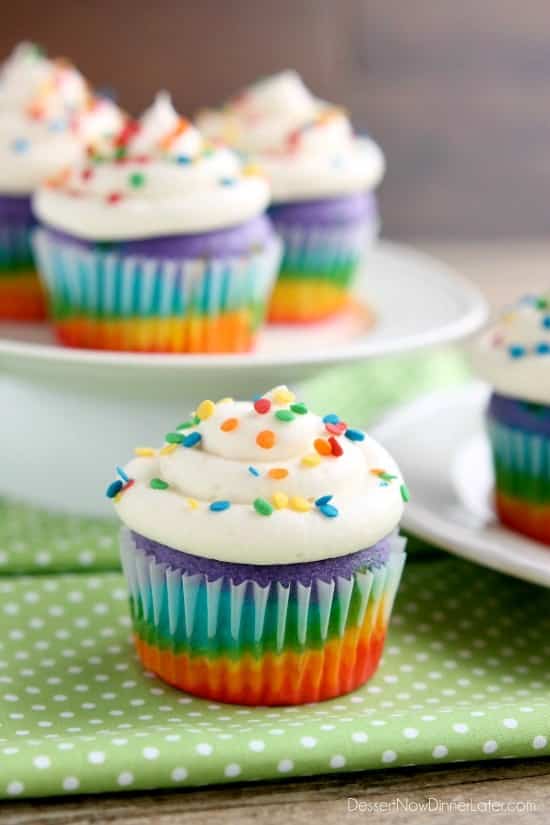 These Rainbow Cupcakes are made with a simple boxed white cake mix, colored, and layered to make a rainbow, with whipped cream cheese frosting on top! (Includes photo tutorial, and tips on baking cupcakes to perfection!)